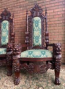 Fine Reproduction Pair Of Colonial Throne Seats With Lion Claw Feet. Circa - Vintage Reproduction Composition- Hardwood Exceptional Pair Of Profusely Carved High Back Throne Chairs. Towering High Backs With Central Coat Of Arms Plaque With Double Pinnacles Leading Down Into Lion Head Armrests. The Decorative Back Rests Hand Carved With Scrolled Acanthus Leaves & Entwined Coats Of Arms With Central Cushioned Panel Finished With Brass Stud Design. A Lovely Wide Seat Upholstered With Rich Green/Gold Silk Decorated With Bouquets Of Flowers, Swags And Tassels. Standing Upon Elaborate Lion Claw Feet With Rose Motifs. Stunning Hand Carved Craftsman Made Hardwood Chairs Finished In French Polished Patina. Original Condition A Museum Quality Pair. Fabulous Pair For Prestigious Collector/ Interior Designer /Film Production Prop. Would Look Amazing Next To Large Fireplace Or In Elaborate Entrance Hall / Lounge Area. Provenance Purchased From Prestigious Castle In The Scottish Highlands. Dimensions In Cms Back Height 185cm Width 90cm Seat Width 52cm Front To Back Depth 73cm
