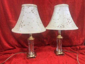 Pair Of Mid Century Stiffel Waterford Crystal & Solid Brass Table Lamps Circa - Mid Century 1970's Compisition - Brass & Cut Crystal Glass Listing Description Stunning Pair Of Rare Stiffel Brass And Cut Crystal Table Lamps In Iconic Hollywood Regency Style. Lamps With Solid Brass Base With Cresent Feet, Cut Crystal Glass Body And Brass Pinnacle Before Bulb Mount. Matching Pair With Original Floral Patterned Silk Shades With Pearl Appliqué. Minor Marks Visible To Shades. (Would Be Removable With Delicate Clean.) Electric Corded Lamps With British Plug. PAT Testing Of Vintage Items Is Advised. Lamps In Full Working Order. Dimensions In Cms Height 50cm including shade X Lamp Stand Height 35cm X Base Width 10cm X Shades 30cm Widest Point.