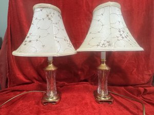 Pair Of Mid Century Stiffel Waterford Crystal & Solid Brass Table Lamps Circa - Mid Century 1970's Compisition - Brass & Cut Crystal Glass Listing Description Stunning Pair Of Rare Stiffel Brass And Cut Crystal Table Lamps In Iconic Hollywood Regency Style. Lamps With Solid Brass Base With Cresent Feet, Cut Crystal Glass Body And Brass Pinnacle Before Bulb Mount. Matching Pair With Original Floral Patterned Silk Shades With Pearl Appliqué. Minor Marks Visible To Shades. (Would Be Removable With Delicate Clean.) Electric Corded Lamps With British Plug. PAT Testing Of Vintage Items Is Advised. Lamps In Full Working Order. Dimensions In Cms Height 50cm including shade X Lamp Stand Height 35cm X Base Width 10cm X Shades 30cm Widest Point.