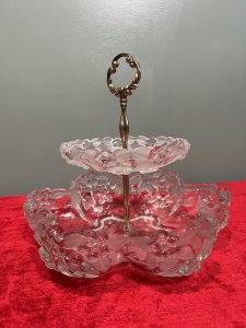 Mid Century Mikasa Walther Crystal Two Tier Cascading Fruit Bowl Circa - 1980 Composition - Glass Listing Description Stunning Top Tiered Fruit Bowl By Mikasa Walther. Each Bowls Shape Is Composition Of Six Circular Lobes Creating Its Scalloped Floral Motif Shape. Top Tier Is Diminishing in Size, With Larger Bowl Base. Stunning Floral Edelweiss Frosted Floral Pattered Cut Crystal Glass With Central Pinnacle With Floral Crescent Handle. Condition - Excellent No Damage - Minor Laquer Tarnishing To Brass Central Stand. Dimensions In Inches Height 9.5" X Width 10.5" (Largest Bowl) For Further Information Please Message or Call 07707 488 566 Thank-you