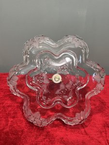 Mid Century Mikasa Walther Crystal Two Tier Cascading Fruit Bowl Circa - 1980 Composition - Glass Listing Description Stunning Top Tiered Fruit Bowl By Mikasa Walther. Each Bowls Shape Is Composition Of Six Circular Lobes Creating Its Scalloped Floral Motif Shape. Top Tier Is Diminishing in Size, With Larger Bowl Base. Stunning Floral Edelweiss Frosted Floral Pattered Cut Crystal Glass With Central Pinnacle With Floral Crescent Handle. Condition - Excellent No Damage - Minor Laquer Tarnishing To Brass Central Stand. Dimensions In Inches Height 9.5" X Width 10.5" (Largest Bowl) For Further Information Please Message or Call 07707 488 566 Thank-you