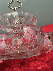 Mid Century Mikasa Walther Crystal Two Tier Cascading Fruit Bowl Circa - 1980 Composition - Glass Listing Description Stunning Top Tiered Fruit Bowl By Mikasa Walther. Each Bowls Shape Is Composition Of Six Circular Lobes Creating Its Scalloped Floral Motif Shape. Top Tier Is Diminishing in Size, With Larger Bowl Base. Stunning Floral Edelweiss Frosted Floral Pattered Cut Crystal Glass With Central Pinnacle With Floral Crescent Handle. Condition - Excellent No Damage - Minor Laquer Tarnishing To Brass Central Stand. Dimensions In Inches Height 9.5" X Width 10.5" (Largest Bowl) For Further Information Please Message or Call 07707 488 566 Thank-you