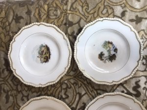 Rare 8Pc Collection Of Limoges France Hand Painted Dessert Comport Plates. Circa 1875 Stunning 8Pc Collection Of Porcelain Comport Plates With Scalloped Gilt Edges With Fine Painted Panels Of Various Landscapes In France Depicting Castles, Cathedrals, River Bridges And Fisherman. Two Plates With Shell Carry Handles For Carrying Desserts And BonBons To The Table Would Be A Fabulous On The Wall Display But Are Perfectly Good To Use Also. Unsigned Please Note There Is A Slight Crack In One Plate Due To Age And Usage. These Are Antique Plates And Have Signs Of Wear Dimensions In Inches Larger Handle Plate - Width 11.5” Diameter 10” 2nd Plate Width With Handle - Width 10.5 Diameter 9.5” 6 Plates Uniform Size Diameter - 9”