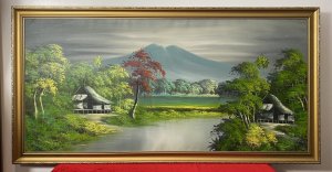 20th Century Indonesian Native Volcanic Settlement Landscape Oil Painting. Medium - Oil On Canvas Circa - 20th Century Striking Background Mountain View Looms With Meandering River With Intricately Painted Native Pagoda Homes In The Foreground. Surrounded By Exotic Foliage Of Palms, Banana Plants And Other Native Specimens. Stunning Perspective With Vibrant Hues Of Green With Blue Volcanic Mountain & Shadows And Accents Of Rich Red. Set In Gilt Wood Frame Unsigned Dimensions In Inches Height 26.5” Width 31.5”