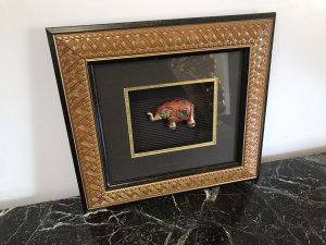 Indian Minature Carved Elephant In A Carved Guilt Picture Frame Carved Wooden Guilded Elephant Set With Faux Precious Stones Set In A Simulated Bamboo Frame With Guilt Hold Edging Dimensions In Inches Height 11.5” Width 13”