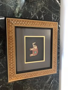 Indian Minature Carved Elephant In A Carved Guilt Picture Frame Carved Wooden Guilded Elephant Set With Faux Precious Stones Set In A Simulated Bamboo Frame With Guilt Hold Edging Dimensions In Inches Height 11.5” Width 13”