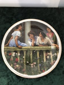 Collection Of 3 Decorative Porcelain Wall Plates Plate 1 By Eugene de Blaas Entitled The Balcony Ladies Gazing Over A Stone Balcony Plate 2 By Myles Burkett Foster Entitled Returning Home Mother And Child Gathering Rhubarb In A Field Plate 3 By Eugene de Blaas Entitled The Proposal Conversation In The Market Square Lovely Colours And Detail Dimensions Diameter 10.5”