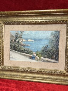 British Fine Art Oil Painting Of Portuguese Coastal View Attributed To Edward Seago Circa - 1950 Composition - Oil On Canvas Brief Artist History Edward Brian Seago March 31st 1910 - January 19th 1974 English Watercolour And Oil Artist Known For Beachscapes And Streetscenes. Edward Seago Briefly Studied With The Painter Sir Alfred Munnings, But Was Mostly Self Taught. Seago Worked In The Late Impressionistic Style Reminiscent Of John Singer Sargent. Seago's Work Is Characterised By Its Very Carefully Observed Colour Modulation And Grounded Sense Of Realism. Edward Seago's Works Are Notably Collected By British Royalty Including Queen Elizabeth, The Queen Mother And Prince Phillip, With Many Of His Finest Artwork Displayed On The Walls Balmoral. Today Seago's Artworks Are Found in Collections Of The Fine Art Gallery San Fransisco, The Royal Collection In London As Well As The National Portrait Gallery London. Listing Description Finely Detailed Impressionist Artwork Attributed To Edward Brian Seago Of Portuguese Coastal View With Forefront Depicting Female Sitting Upon A Wall On Roadside, Fabulous Sea View Behind With Surrounding Native Foliage, Central Coastal Town Bay And Sea Line Flowing Into The Distance. Vibrant Colour Palette Showing Landscape In Vivid Sunshine With Clear Skies And Rich Blue Seas. Quality Artwork Signed E SEAGO Set With Canvas Boarder In Original Gilt Frame. Condition - Excellent Showing Signs Of Damp To Canvas Boarder. Paintwork In Good Order. Dimensions In Inches Frame Height 14.5" X Width 18.5" Painting Height 6.5" X Width 10.5"