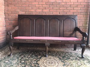 Period Antique 1760 George III Four Panel ‘Great Hall’ Oak Settle. Solid Oak Bench With Gothic Panelled Back, Sweeping Elegant Arm Rests With Red Fleur De Lys Style Motif Upholstered Cushion And Ship Work Roping Supports. Cabriole Shape Leg Supports Hand Carved During The Reign Of George III 1760 Provenance Part Of Lord Hill Museum Collection Please Note This Is A Genuine Antique Dated 1760 Due To Age There Are Signs Of Wear The Back Left Leg Has Previously Been Mended A Metal Brace Fitted For Support Dimensions In Inches Height Width Depth
