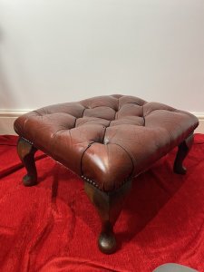 Vintage Deep Buttoned Red Leather Chesterfield Footstool Set Upon Mahogany Queen Anne Legs Circa - Vintage Composition - Wood Frame/ Leather Upholstery Listing Description Wonderful Vintage Original Red Deep Buttoned Leather Upholstered Footstool In Iconic Diamond Chesterfield Pattern. Rectangular Shape With Hardwood Frame With Decorative Polished Mahogany Queen Anne Legs. Condition - Very Good Used Showing Minor Scratches/ Signs Of Wear Due To Usage / A Slight Tear To Leather Please See Images. Dimensions In Inches Height From Floor 12" Width 24" Depth 19"