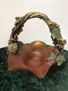 French Reproduction Ornate Grape Vine Handle Orange Art Glass Fruit Bowl Porcelain Grape Vine Handle With Purple Fruit And Green Vine Leaves With Stunning Shaped Burnt Orange Frosted Glass Fruit Bowl Decorative Item Pristine Condition Dimensions In Inches Height 11” Width 12”