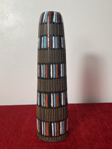 Designer Italian Mid Century Modern Textural Leaning Tower Of Pisa Inspired Vase Circa - 1950's Composition - Earthenware Tall Mid Century Earthenware Cylindrical Leaning Vase With Inspiration From The Leaning Tower Of Pisa. The Hand Sculpted Body Of the Vase Is Made Of Parallel Textural Lines Pattern And Decorated With Rings Of Gloss Coloured Paint Strokes In Blue, White, Red Which Mimic The Windows Of The Leaning Tower Of Pisa. Lovely Useful Collectors Piece In Vivid Colour. Signed On Base. Dimension In Inches Height 11 3/4" Base Diameter 3" Mouth Diameter 1 3/4"