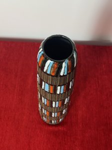 Designer Italian Mid Century Modern Textural Leaning Tower Of Pisa Inspired Vase Circa - 1950's Composition - Earthenware Tall Mid Century Earthenware Cylindrical Leaning Vase With Inspiration From The Leaning Tower Of Pisa. The Hand Sculpted Body Of the Vase Is Made Of Parallel Textural Lines Pattern And Decorated With Rings Of Gloss Coloured Paint Strokes In Blue, White, Red Which Mimic The Windows Of The Leaning Tower Of Pisa. Lovely Useful Collectors Piece In Vivid Colour. Signed On Base. Dimension In Inches Height 11 3/4" Base Diameter 3" Mouth Diameter 1 3/4"