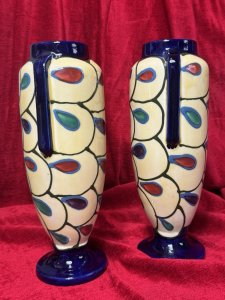 Pair Of Art Deco Ditmar Urbach Czechoslovakian Art Pottery Vases Listing Description Exceptional Sought After Period Art Deco Ditmar Urbach Art Pottery Vases. A Czechoslovakian Art Pottery Company Best Known For Decorative Pieces In The Art Deco Style, Their Primary Production Period During 1920-1930, With A Focus On Hand Painted, Distinctive Forms And Unique Sculptural Pieces. These Art Pottery Pieces Are now Highly Collectable Amongst Collectors Of The Art Deco Period. This Pair Of Tall Vases Showcase A Geometric Style Pattern Of Stylised Teardrop Shaped Motifs, In Plum, Blue And Green With Cream Body And Dark Blue Mouth And Base. Both Have Matching Markings On The Base. Stunning Original Condition. Kindly Call The Museum Curator For More Information On 07707 488566 Thank-you. Dimensions In Cms. Height 29cm x Width 13cm x Mouth 6.5cm x Base 9cm