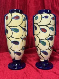 Pair Of Art Deco Ditmar Urbach Czechoslovakian Art Pottery Vases Listing Description Exceptional Sought After Period Art Deco Ditmar Urbach Art Pottery Vases. A Czechoslovakian Art Pottery Company Best Known For Decorative Pieces In The Art Deco Style, Their Primary Production Period During 1920-1930, With A Focus On Hand Painted, Distinctive Forms And Unique Sculptural Pieces. These Art Pottery Pieces Are now Highly Collectable Amongst Collectors Of The Art Deco Period. This Pair Of Tall Vases Showcase A Geometric Style Pattern Of Stylised Teardrop Shaped Motifs, In Plum, Blue And Green With Cream Body And Dark Blue Mouth And Base. Both Have Matching Markings On The Base. Stunning Original Condition. Kindly Call The Museum Curator For More Information On 07707 488566 Thank-you. Dimensions In Cms. Height 29cm x Width 13cm x Mouth 6.5cm x Base 9cm