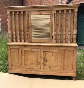 Mid 19th Century Pine Pillared Housekeepers Cupboard Stunning Turned Pillars All Around The Top Cupboard Centred Mirrored Door With Storage Hooks For Hanging Housekeeping Items Two Door Cupboard At The Bottom With Shelving And Storage Space Stunning Honey Pine A Lovely Golden Colour Stands On Turned Bun Feet Heavy Item Top Lifts Off Exceptional Antique Piece Dated 1875 Made In Cheshire By A Local Cabinet Maker Was Purchase From A Manor House Would Be Perfect On A Manor Or Farm House Stunning Conversation Piece Weight Approx 90kg Dimensions In Inches Height 72.5” Width 69” Depth 27”