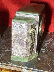 French Art Deco Marble Mantle Clock With Matching Garnitures Circa - 1920 Composition - Solid Marble/ Metal Filigree Listing Description Exceptional Period Art Deco Mantle Clock Garniture. Timepiece Comprised Of Rectangular Central Pediment, With Surrounding Canted Corner Pediments Set Upon Ornate Green Marble Feet And Matching Top Housing. All Embellished With Ornate Floral Plaques. Oval Brass Numeral Dial Run By 8 Day Mechanical Movement Wound On Clock Face. Set Complete With Pair Of Matching Octagonal Candles Garnitures. Dimensions In Inches Clock Height 8 3/4" X Width 13.5" X Depth 5 1/4" Garnitures Height 5.5" X Width 5 1/4" X Depth 4 1/4" For Any Further Information Please Call The Curator On 07707 488 566 Thank-you