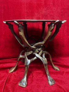 Decorative Brass Charger And Carved Camel Base Fruitwood Occasional Table Circa - Vintage Composition - Fruitwood/Brass Top Listing Description Ornate Floral Engraved Brass Charger Table Top Sits Upon A Carved Camel Pediment Base. The Base Is Carved Out Of A Single Piece Of Wood. The Base Constantinas Out For Table Construction Then Neatly Folds Down. Dimensions In Cm Height 43cm X Width 48cm
