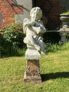 Cherub ‘The Horn Blower’ Garden Showpiece Circa - 1890 Composition- Reconstituted Stone Cherub With Iron Base Listing Description Classical Large Winged Putti Garden Statue In Fine Detail, Posed Blowing Musical Horn And Sat With Loin Cloth Upon Fluted Base. Set Upon Cast Iron Plinth. Stunning Feature For Period Garden Setting. Provenance Purchased From Country Estate In Kent. Dimensions In Cm Total Height 108 cm Statute Width 33cm Base 37cm X 27cm Depth