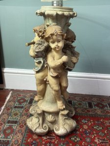Trio of musical cherubs occasional table Composition - Resin and glass Circa - Vintage Listing Description Ornate table base comprised of entwined cherub figures each holding a different musical instrument (loot, harp, and flute) A richly coloured three dimensional piece with circular glass top. Dimensions in Cms Height 61cm X Top Width 50cm X Base Width 28cm