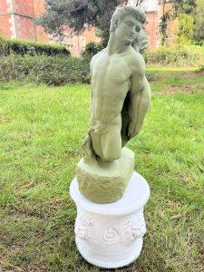 Set Upon Circular Plinth Base With Lion Head Decoration. Circular Plinth Height 31cm X Circumference 32cm. Statue Height 51cm X Width 23cm X Depth 18cm at base.