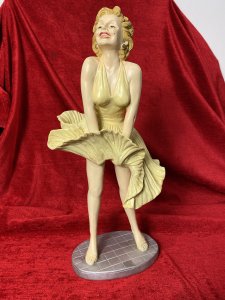 Wearing Designer William Travilla White Cocktail Dress, With Her Skirt Blowing Upwards Due to A Underground Passing Train. Sculpture From Original Image From 1955 Film 'The Severn Year Itch' Directed By Billy Wilder.