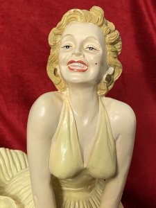 Wearing Designer William Travilla White Cocktail Dress, With Her Skirt Blowing Upwards Due to A Underground Passing Train. Sculpture From Original Image From 1955 Film 'The Severn Year Itch' Directed By Billy Wilder.
