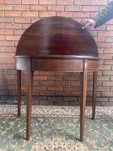 Stunning Period Antique George III Demi Lune Tea Table In Rich Plum Mahogany. Demi Lune Top Folds Out To Create Circular Turn Over Table Top With Decorative Satinwood Herringbone Inlays All Around Top Edge Set On Original Antique Brass Hinges.