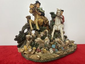 Beautiful Hunting Centrepiece Of Lady Riding Side Saddle On Tan Horse And Gentleman Riding Grey Horse In Red Hunting Jacket. Both Jumping Over Picket Fence With Five Beagle Dogs. Height 10".