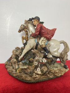 Beautiful Hunting Centrepiece Of Lady Riding Side Saddle On Tan Horse And Gentleman Riding Grey Horse In Red Hunting Jacket. Both Jumping Over Picket Fence With Five Beagle Dogs. Height 10".