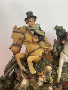 Beautiful Hunting Centrepiece Of Lady Riding Side Saddle On Tan Horse And Gentleman Riding Grey Horse In Red Hunting Jacket. Both Jumping Over Picket Fence With Five Beagle Dogs. Height 10".