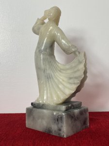 Oriental Kimono Jacket With One Hand Holding Pleated Full Length Skirt. Set Upon Rectangular Stepped Plinth. Composition - Jade Hardstone. Height 9 3/4".