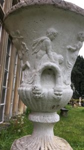 Large Roman Style Campagna Shaped Urn With Scalloped Edges. With Small Dwarf Palm Tree. Composition- Reconstituted Stone. Stunning Piece For Garden Centrepiece Display Of Flowers. Showing Signs Of Weathering Due To Age & Usage.