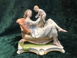 Stamped On Base And Signed By Artist Redwell. This Is A Fine Example Of 20th Century Capodimonte Artwork In Hand Paste Porcelain. Exhibited At The Lord Hill Museum. A Lady Reclining On A Chaise Longe Holding Her Child In The Air.