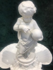 Putti Standing On Pile Of Books With A Globe In Hand, In The Form Of A Water Fountain. Masked Heads In Oyster Shell Shaped Trio Of Dishes For Fruits/ BonBons Or Canapés. Table Centre Piece Fruit Comport/ Statue.