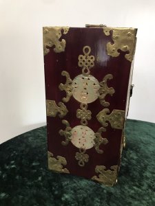 Vintage Oriental Brass Bound Jade Panelled Jewellrey Casket Beautiful Casket With Two Doors Revealing Three Internal Shelves And Opening Bottom Drawer Front And Two Side Panels Have Fine Shaped Jade Carved Insets With Ornate Brass Engraving Ornate Brass Carry Handle On The Top Shaped Feet Very Ornate Unusual Casket Perfect For Jewels, Documents Or Trinkets Made From Hardwood With Quality Workmanship Circa - 1950’s Origin - China Dimensions In Inches Height 11” Width 7 1/4” Depth 5.5” Weight Approx 10kg