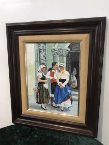 Original Contemporary Spanish Wedding Party Oil On Board Painting Signed By Artist AIXADO Spanish Bride In The Church Doorway With Three Guests Outside The Church In Traditional Clothing Bright Hues And Lovely Detail Mahogany Hardwood Frame With Velvet Boarder Signed Front And Back By The Artist Dimensions In Inches Height 21” Width 17.5” Frame Depth 1.5”