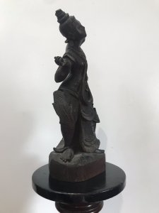 Antique Wood Carving Thai Buddha Figural Female Statue Fine Carved Details Interesting Hardwood Sculpture On Wood Base Genuine Antiquity 19th Century Sculpture Please Note- Right Arm Missing, Fingers Missing Off Left Hand, Component Missing On Back. All Due To Age Of The Piece. Adds To Charm Of The Item Dimensions In Inches Height 19” Width 7.5” Weight Approx 5KG