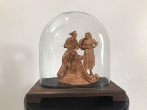 Victorian Terracotta Sculpture ‘Fisherman Mending His Net’ Signed S NO GRASSO. Fisherman Sits Smoking A Pipe Bare Foot On A Rock Whilst Mending His Fishing Net. Lady With Basket Over Her Shoulder Stands Taking To The Fisherman. Terracotta Sculpture In Glass Dome On Wooden Plinth Lovely Condition And Charming Subject Circa 1890 Paris Signed On The Back By The Artist Dimensions In Inches Height 9” Width 9.5”