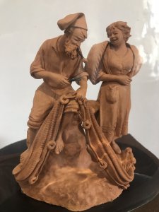 Victorian Terracotta Sculpture ‘Fisherman Mending His Net’ Signed S NO GRASSO. Fisherman Sits Smoking A Pipe Bare Foot On A Rock Whilst Mending His Fishing Net. Lady With Basket Over Her Shoulder Stands Taking To The Fisherman. Terracotta Sculpture In Glass Dome On Wooden Plinth Lovely Condition And Charming Subject Circa 1890 Paris Signed On The Back By The Artist Dimensions In Inches Height 9” Width 9.5”