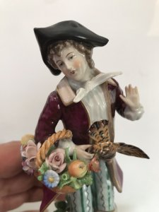 Pair Of 18th Century Style Chelsea Figurines Lady And A Gentleman Gathering Fruit And Game Standing On Shaped Gilded Plinths Painted In Bright Hues The Detail On These Figurines Is Breathtaking Chelsea Markings On The Bases Slight Damage On The Gentleman’s Forefinger Provenance Purchased From The Lord Hill Museum Shropshire Dimensions In Inches Height 7 1/4” Base 3” Square