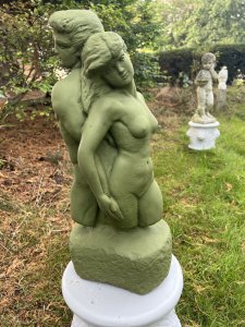 Set Upon Circular Plinth Base With Lion Head Decoration. Circular Plinth Height 31cm X Circumference 32cm. Statue Height 51cm X Width 23cm X Depth 18cm at base.