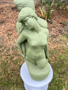 Set Upon Circular Plinth Base With Lion Head Decoration. Circular Plinth Height 31cm X Circumference 32cm. Statue Height 51cm X Width 23cm X Depth 18cm at base.
